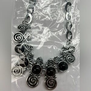 Black and silver colored necklace and earrings set